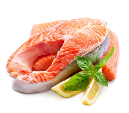 Raw Salmon Red Fish Steak with Herbs and Lemon isolated on White