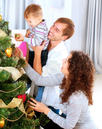 Happy Family Decorating Christmas Tree together