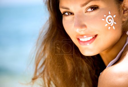 Girl Applying Sun Tan Cream on Face.