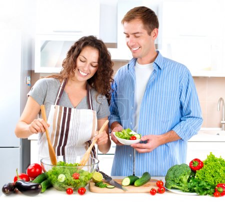 Young Couple Cooking Vegetable Salad Together