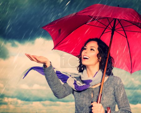 Smiling Woman with Umbrella over Autumn Rain Background
