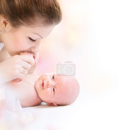 Newborn Baby. Happy Mother and Baby kissing and hugging