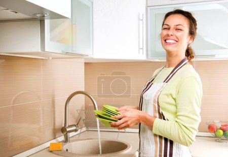 Woman Washing Dishes. Kitchen