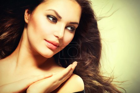 Beautiful Brunette Woman with Blowing Healthy Hair
