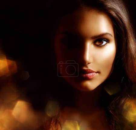 Beauty Girl Dark Portrait with Golden Sparks. Mysterious Woman