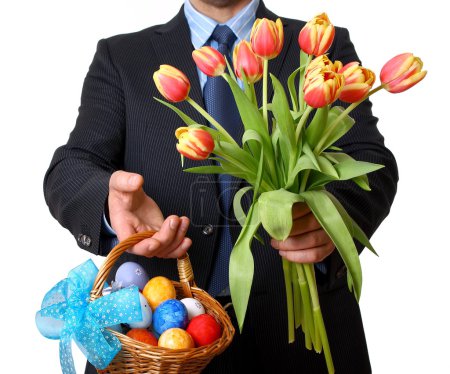 Man in suit and tie gives tulips and Easter basket
