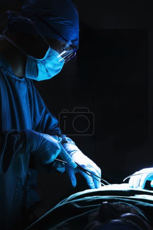Surgeon holding surgical equipment