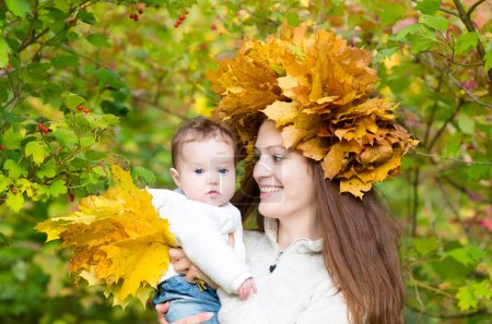 Mother in a maple leaf wreath holding a sweet baby girl