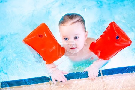 Toddler having fun in a swimming pool