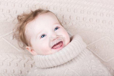 Cute gunny baby girl in a knitted sweater