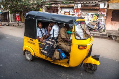 THANJAVUR, INDIA - FEBRUARY 13: Children go to school by auto ri