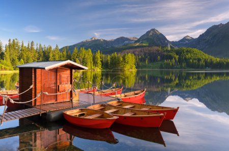 Red boat in a mountain lake