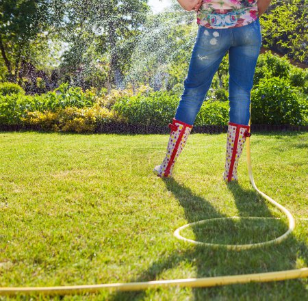 Woman holding garden water hose