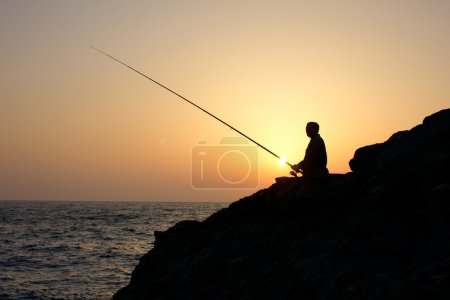 angler on sunset fishing