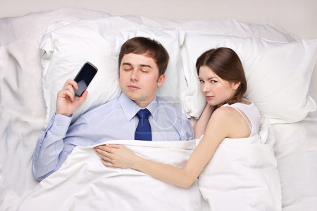 businessman and woman in bed