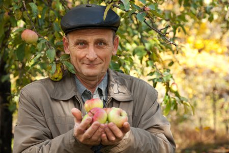 Thoughtful middleaged man with apples
