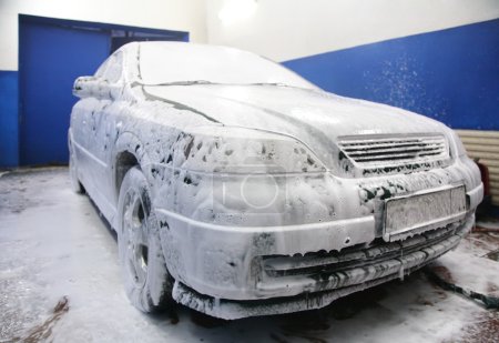 Automobile in soapsuds on washing