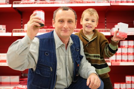 Grandfather and grandson in food shop