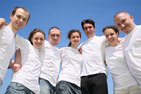 Group of friends in white T-shorts are in a circle