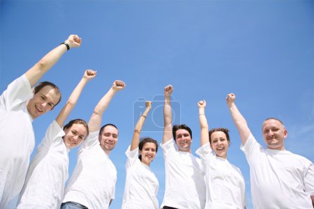 Group of friends in white T-shorts have waved upwards hands