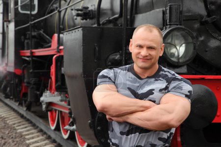 Strong man against locomotive