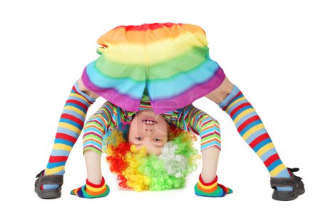 Little boy in clown dress somersault isolated on white