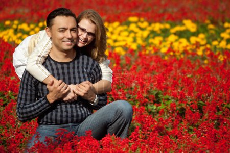 Man and woman in brackets laughing in the flowers