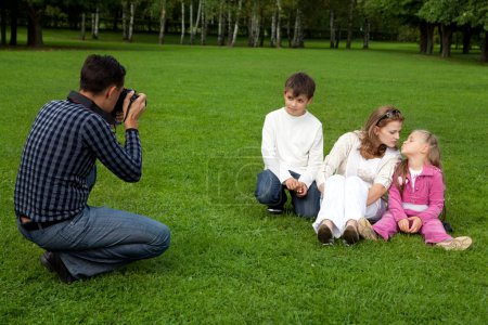Man photographes his family outdoors