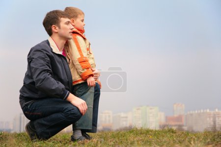 Father and son outdoors on grass
