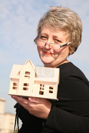 Senoir woman with house model