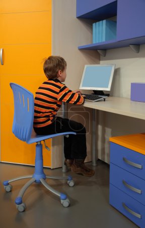 Boy at computer in children's room