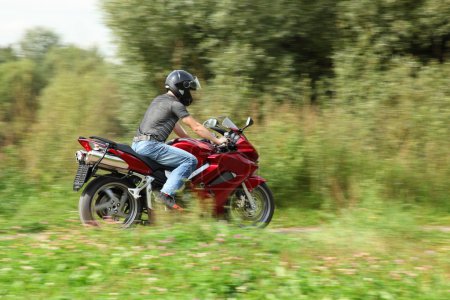 Motorcyclist riding on country road