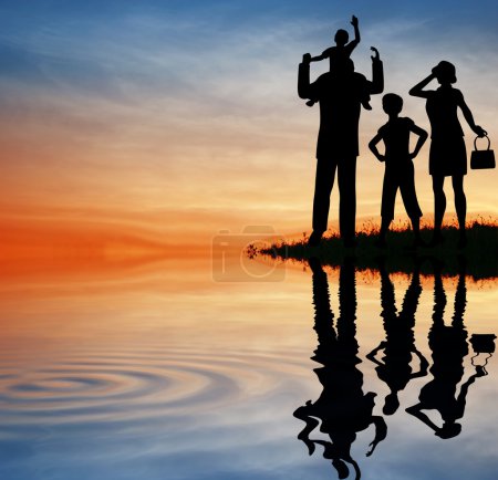 Family silhouette on sunset sky. water