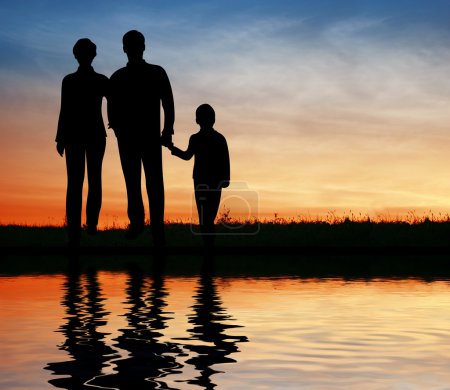 Silhouette family on sunset coast