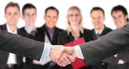 Shaking hands with wrists and six business group out of focus co