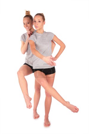 Twin sport girls posing balancing