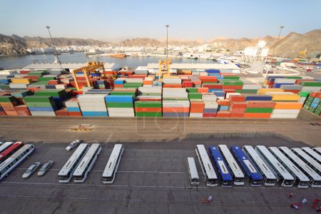 Shipping port with buses and containers for cargo transportation