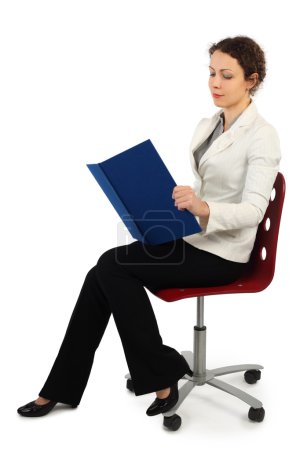 Young attractive woman in business dress sitting on chair and re