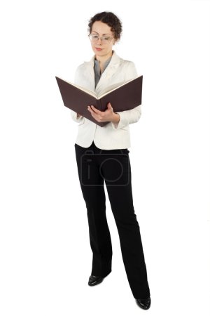 Young attractive woman in business dress standing and reading bi