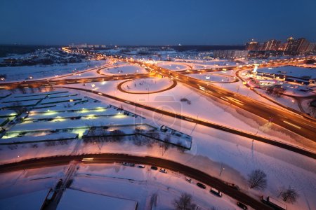 Evening winter cityscape with big interchange and lighting colum