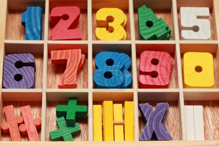 Math game for junior age with colored wooden signs of numbers ho