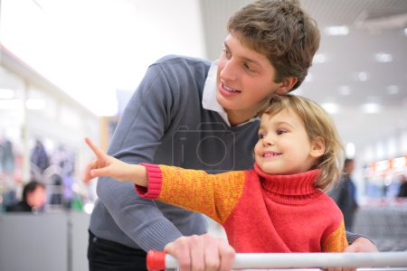 Father with child in shop
