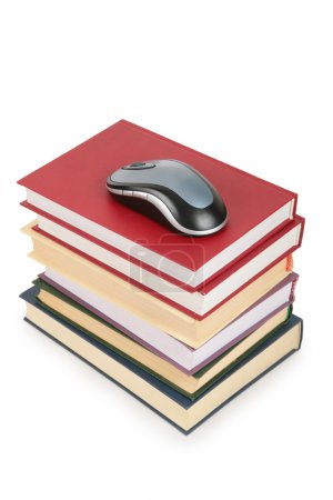 Computer mouse on pile of books