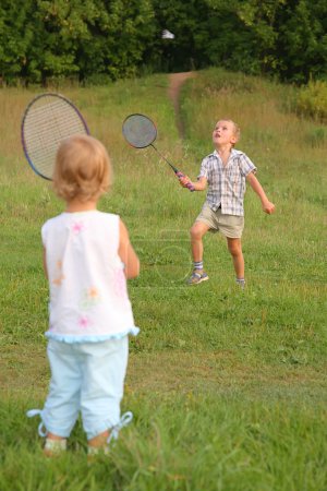 Boy and girl play badminton