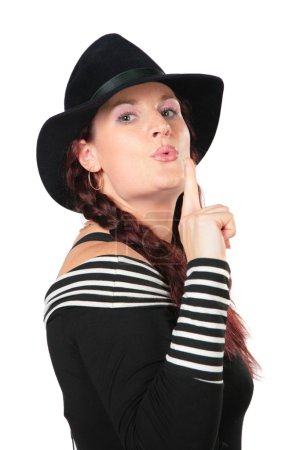 Portrait of beauty woman in black hat makes gesture by finger