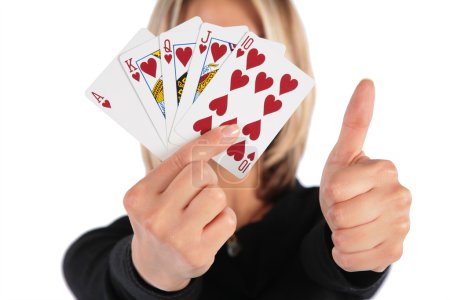 Woman holds cards in hand and does gesture by thumb