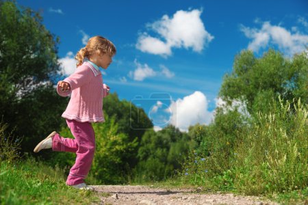 Little girl runs across path outdoor