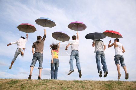 Jumping group with umbrellas
