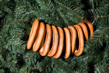 Sheaf of bagels hanging on Christmas fur-tree, ten bagels