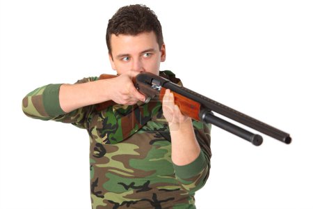 Man in camouflage aims from gun